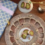 Premium dried figs and cashews arranged beside finished Anjeer Cake