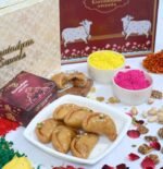 Close-up of Gujiya with flaky golden crust and visible mawa dry fruit filling