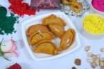 Close-up of Gujiya showing its rich, flaky layers and filling.