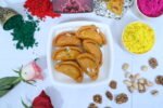 Gujiya served with a bowl of thandai for a festive treat.