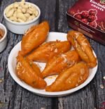 Close-up of golden Gujiya with sweet mawa and dry fruit filling