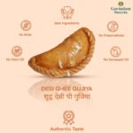 Gujiyas served on brass plate with Holi color powders and marigold flowers