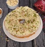 Malai Ghewar on a traditional thali with festive decorations
