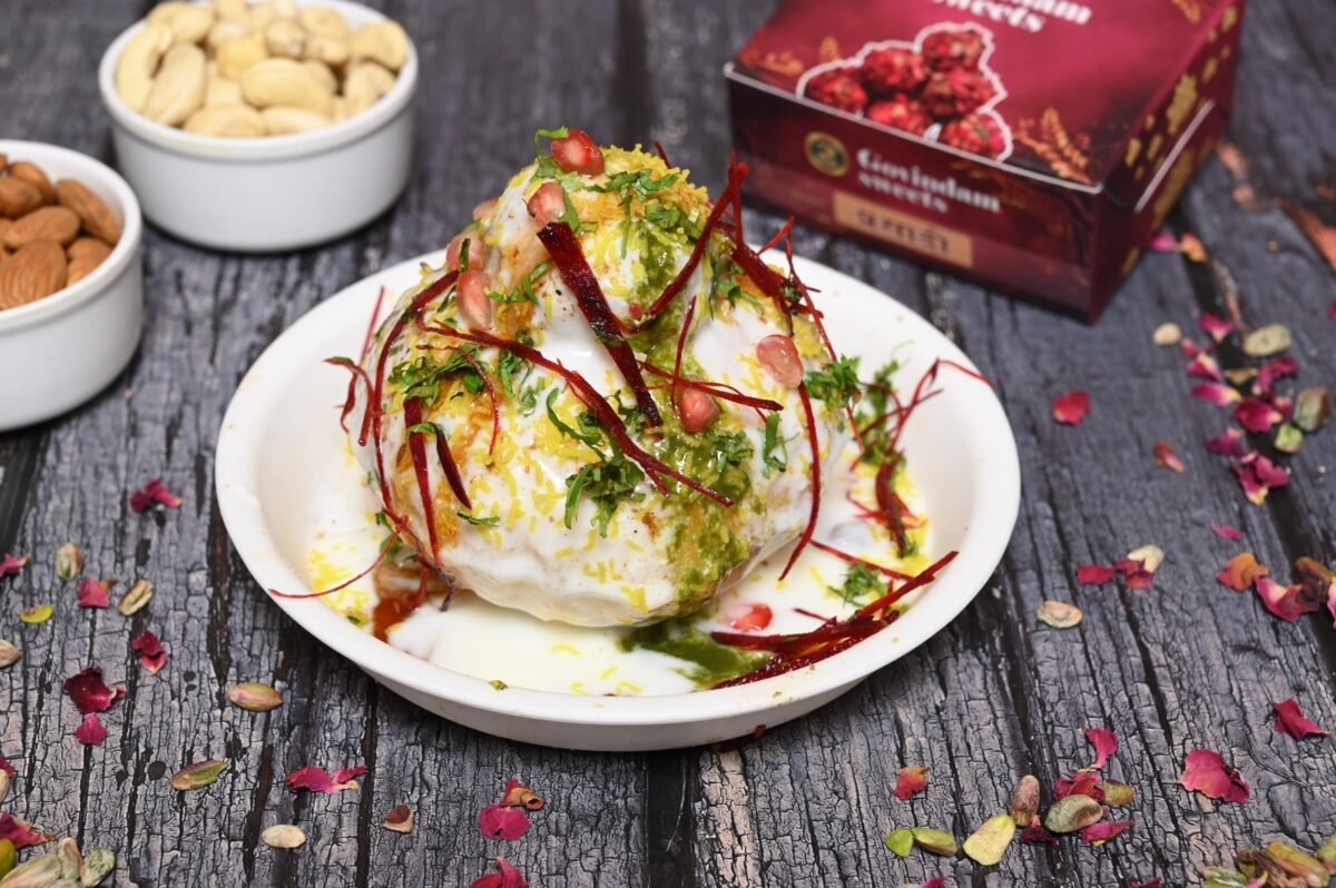 Crispy and stuffed Raj Kachori topped with chutneys and sev.