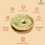 Close-up of Malai Ghewar topped with thick rabri and chopped dry fruits