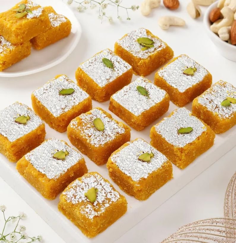 Close-up of Moong Dal Barfi with golden color and almond-pistachio topping