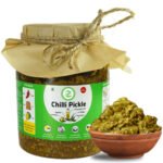 Athana Mirchi Achar B2B wholesale showing traditional hand stuffing process green chilies with spice blend